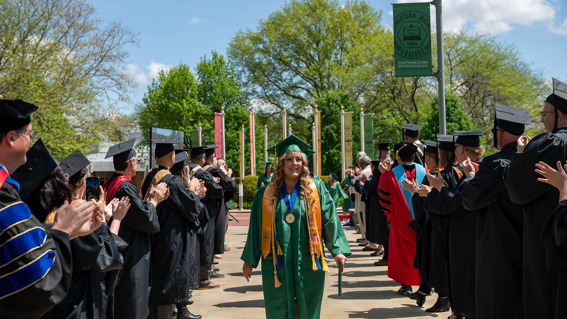 SMC faculty celebrating recent graduates.