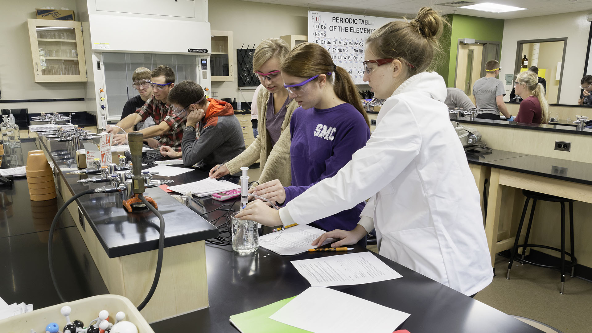 Students performing an experiment in a lab