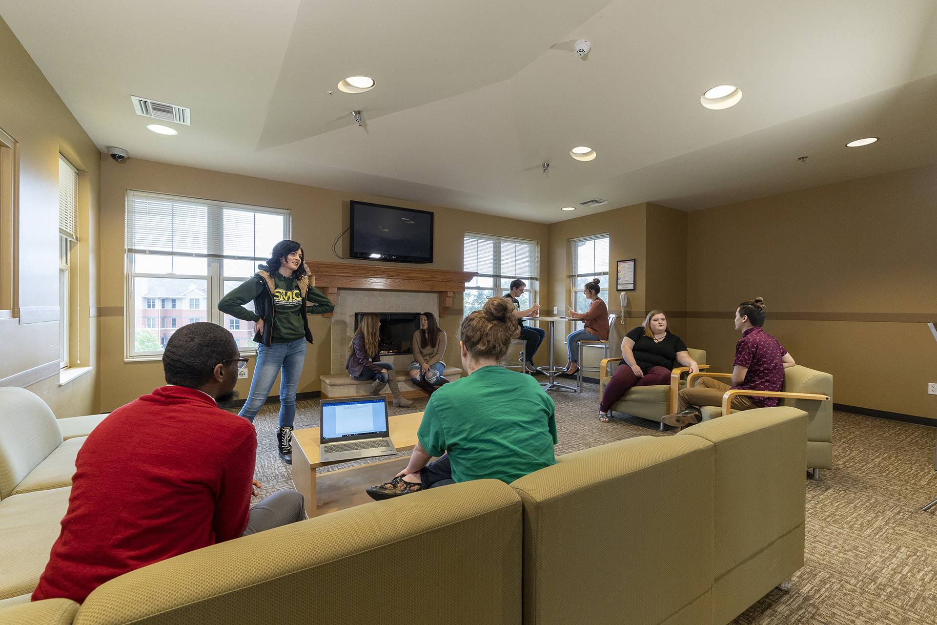 Students talking and watching TV in the Residence Halls common area