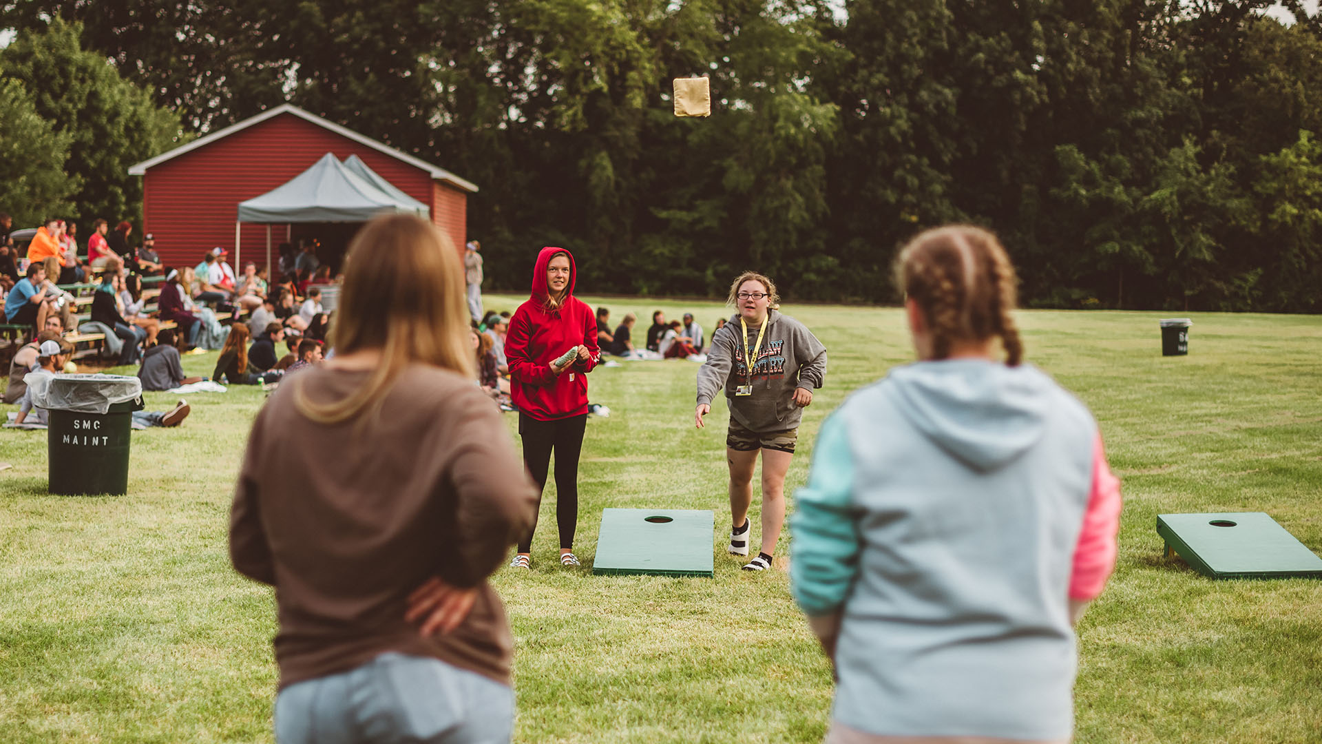 Student activities include outdoor games, like cornhole.