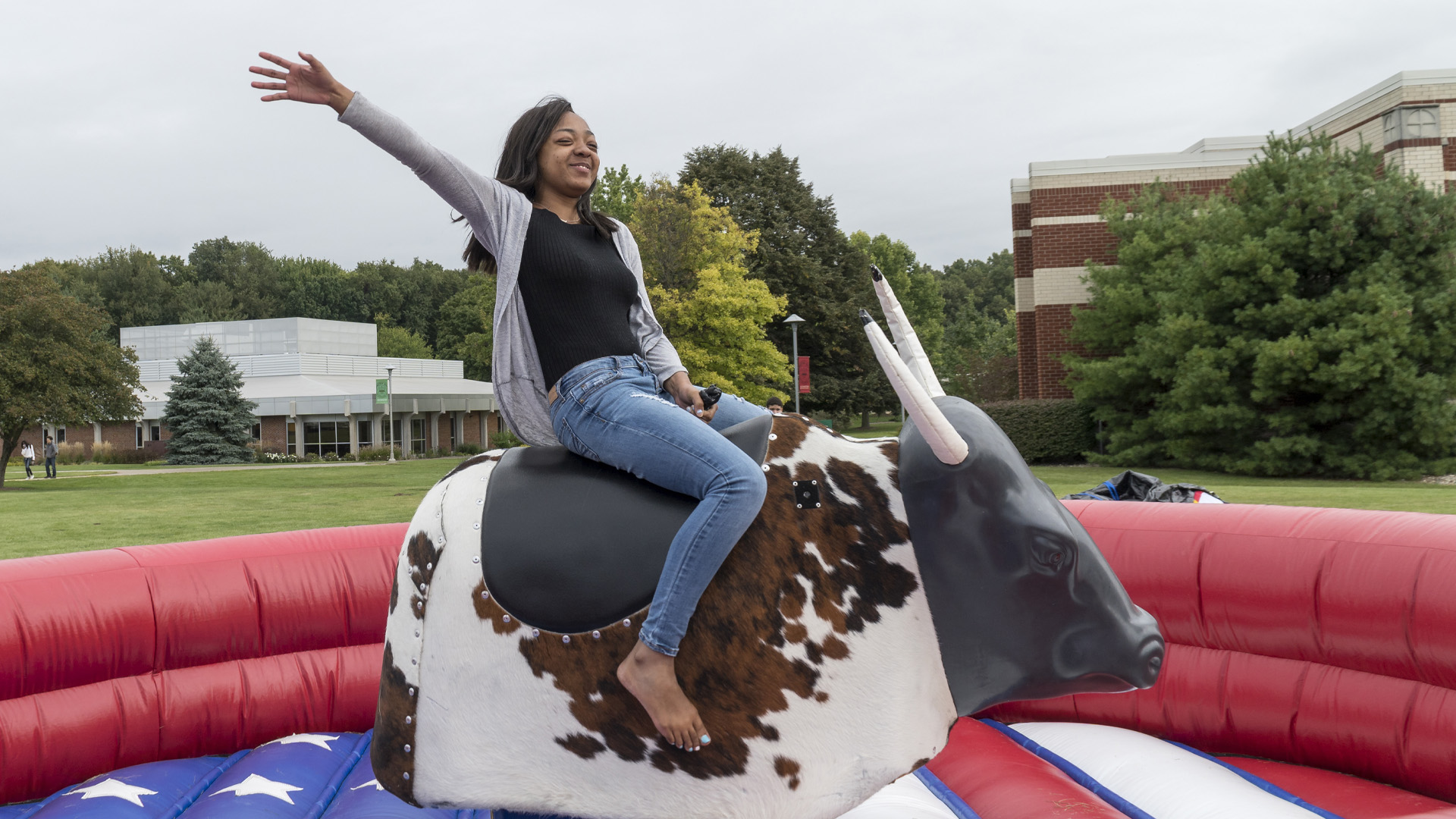 Student riding a mechanical bull during campus bash