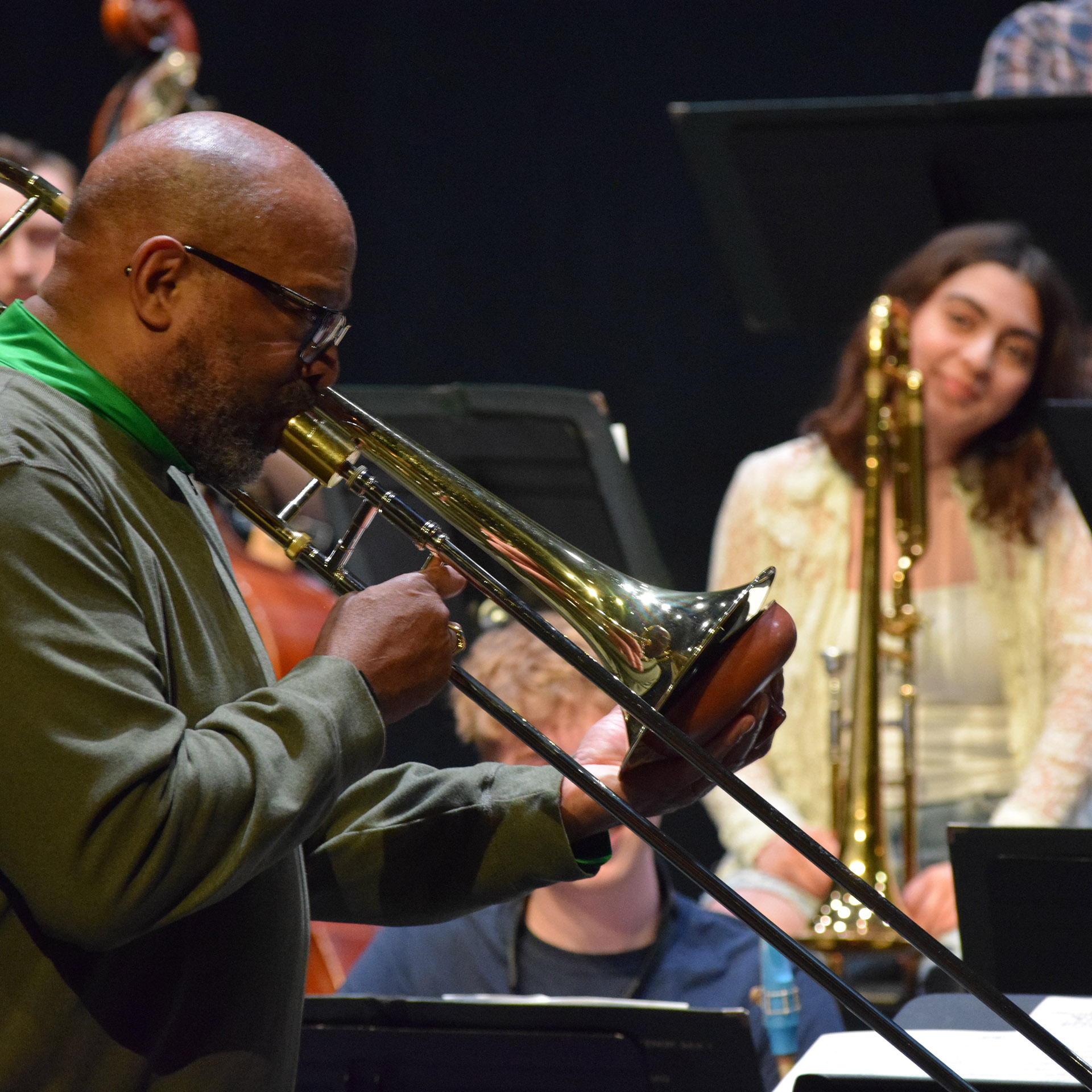 Aliya Leavitt, Paw Paw, listens to Dennis Wilson play trombone