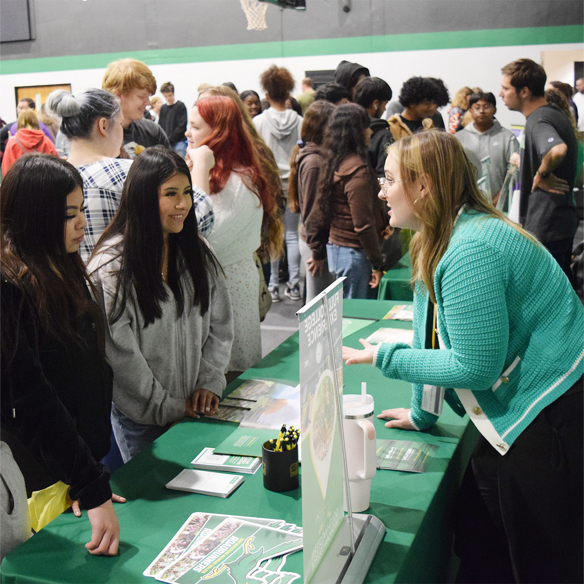 Courtney Mathews and Ben Spencer interact with students at SMC's table